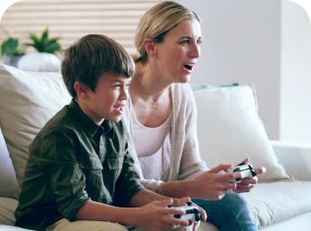 Parent and child gaming on the sofa