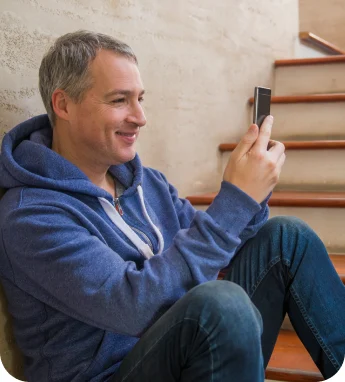 Man using his phone at home