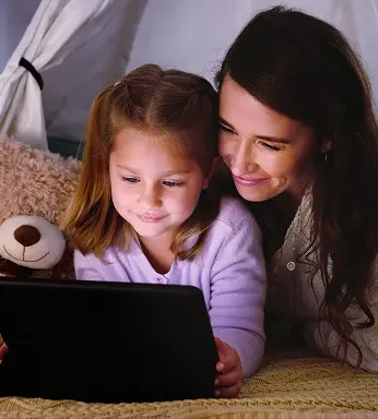 Two children watching a tablet together