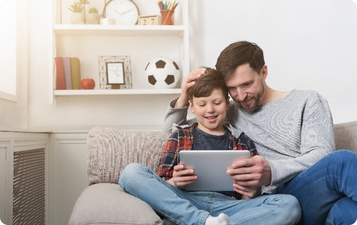 A family streaming together on a tablet